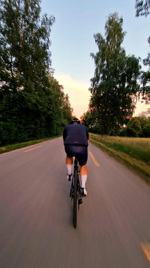 Cycling road footage with OVRLEY route, power, heart rate, speed, elevation, and gradient widgets.