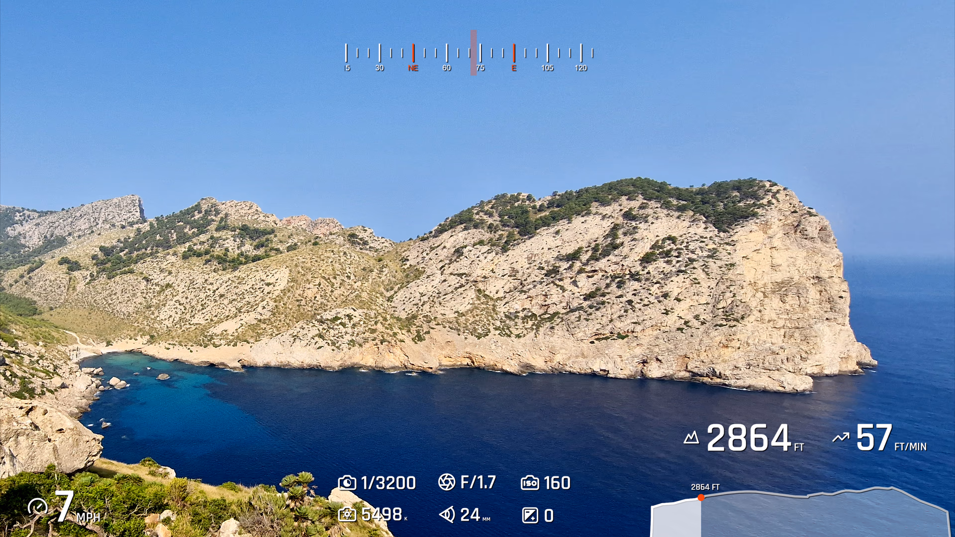 Coastal overlook footage with heading, camera settings, speed, altitude, and elevation profile widgets.
