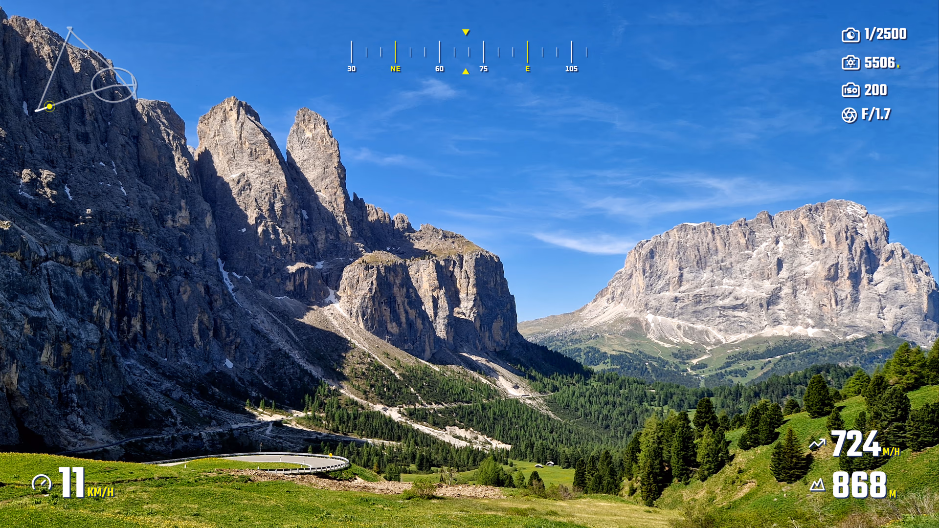 Mountain landscape footage with heading, route trace, camera settings, speed, and elevation widgets.