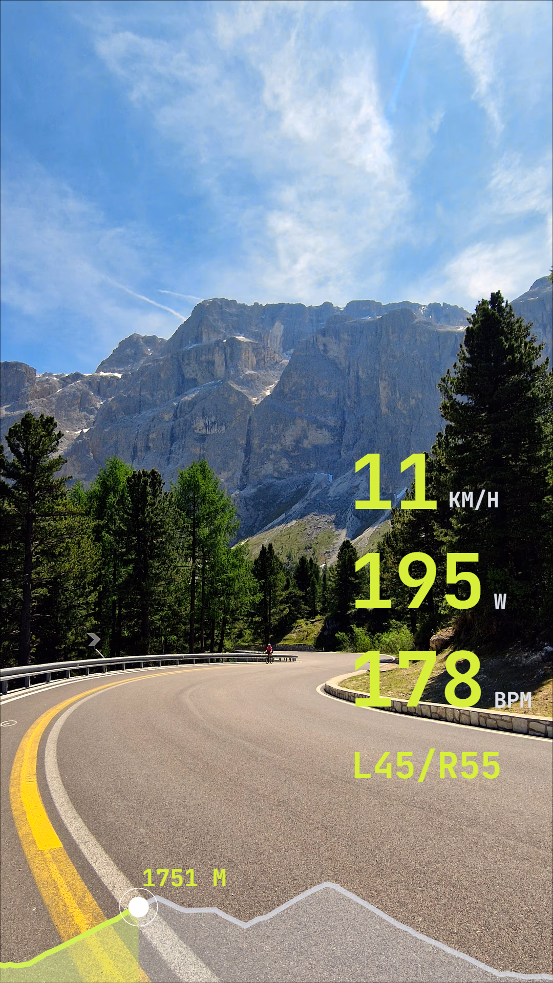 Portrait mountain road footage with large speed, power, heart rate, balance, and elevation widgets.