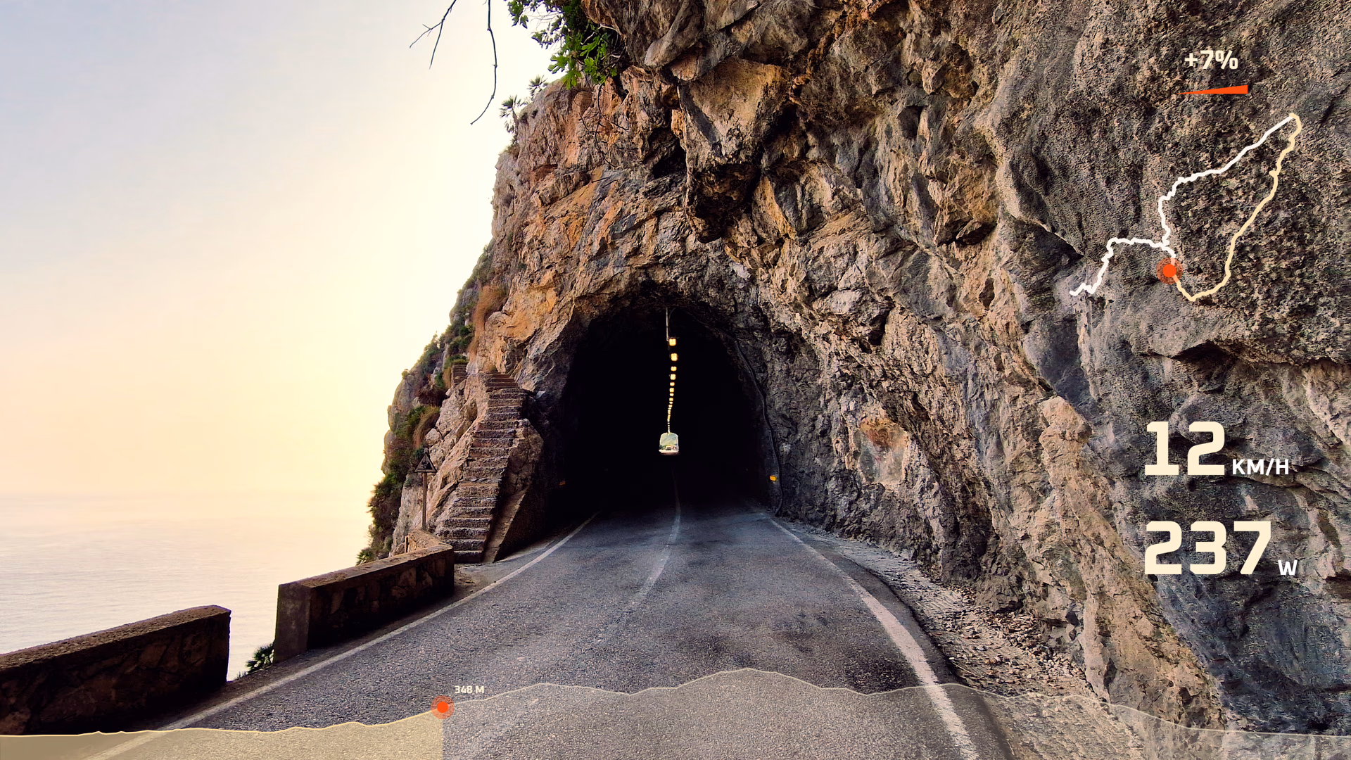 Tunnel entrance footage with route, speed, power, elevation, and gradient widgets.